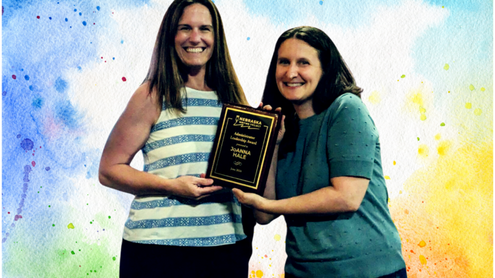 JoAnna Hale and Rachael Shah stand next to each other, holding an award plaque