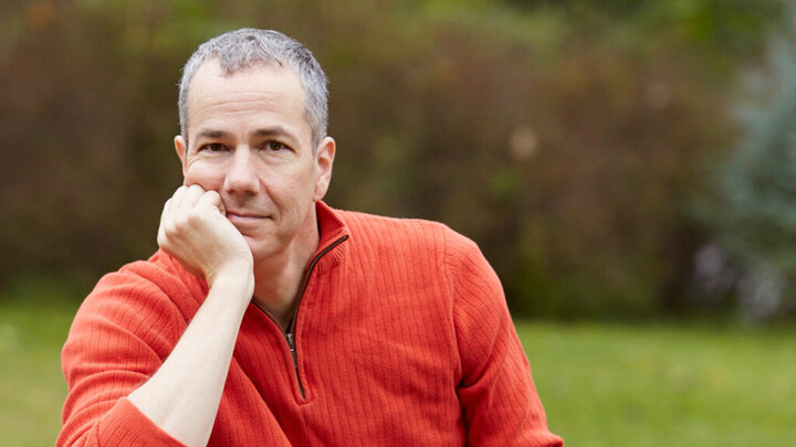 A photo of Matt Mason in an orange shirt