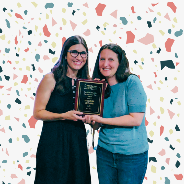 Award Winner Melissa Legate and NeWP Director Rachael Shah stand next to each other holding an award plaque